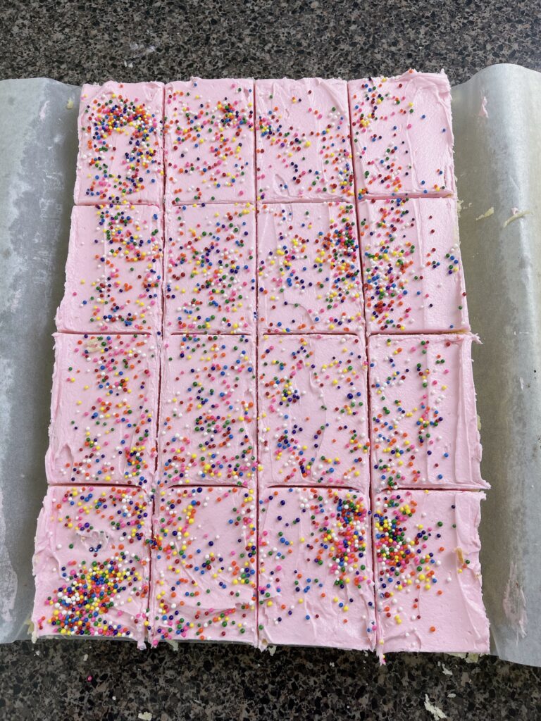 Cream cheese sugar cookie bars cut into squares.