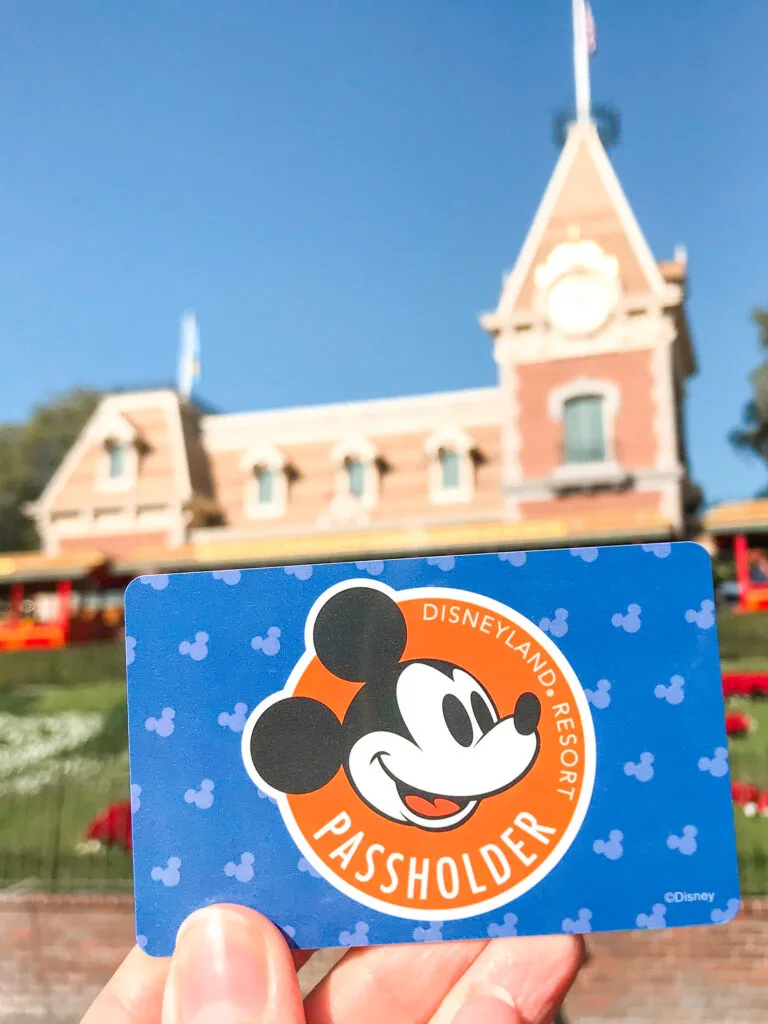 A Disneyland annual pass in front of the Disneyland Railroad.