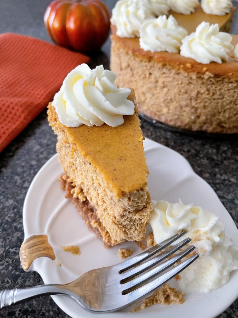 A slice of copycat Cheesecake Factory pumpkin cheesecake with a fork.