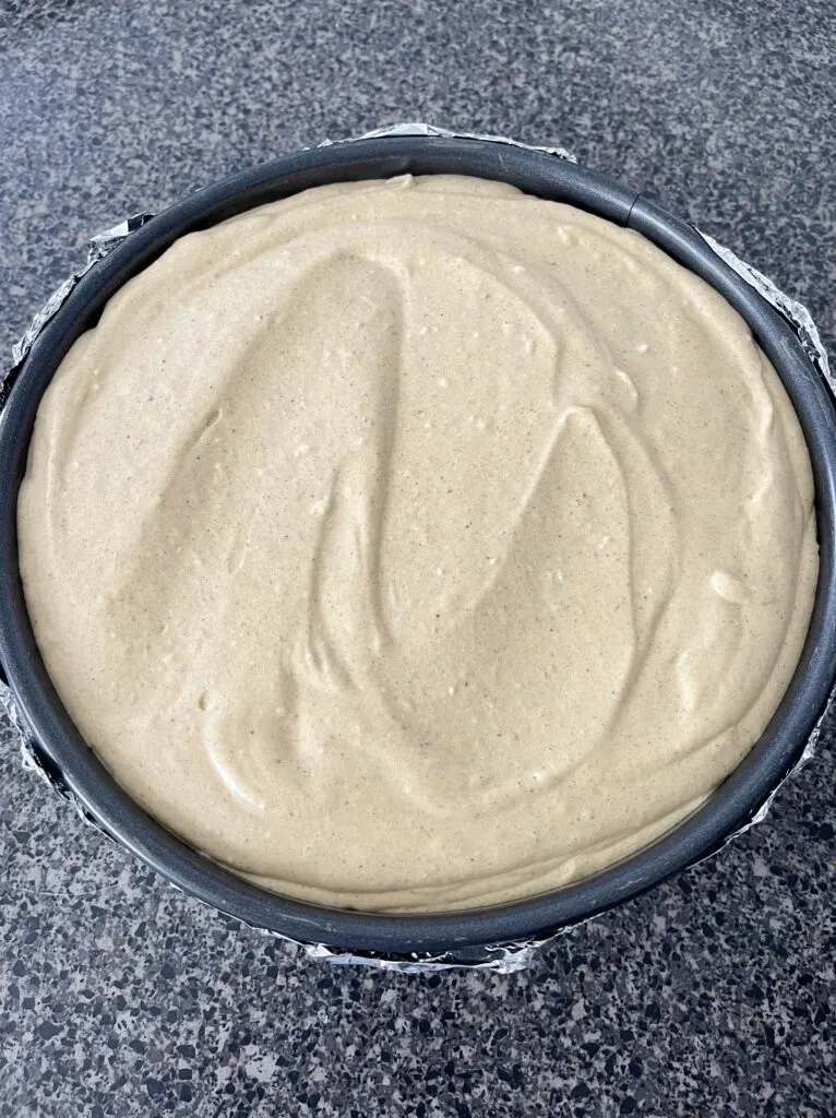 Pumpkin cheesecake batter in a springform pan.