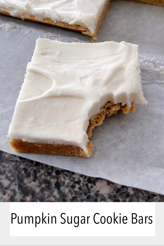 A pumpkin sugar cookie bar with cream cheese frosting.