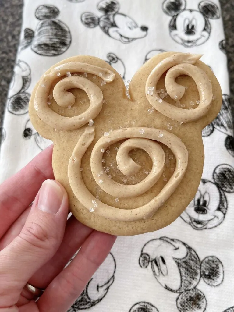 A Mickey Mouse-shaped churro sugar cookie swirled with churro frosting.