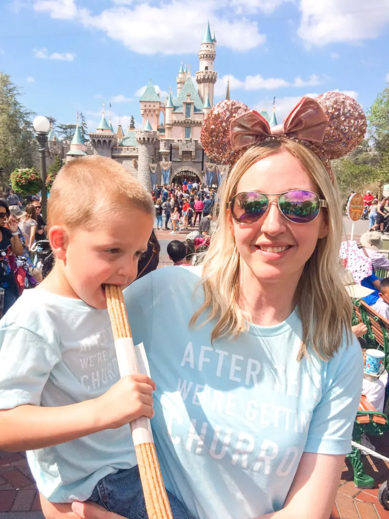 A little boy and his mom eating a churro at Disneyland.