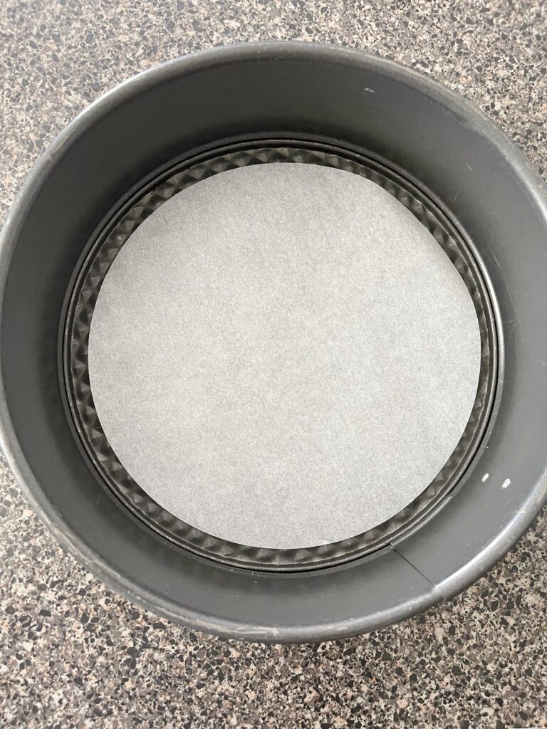 Parchment paper inside a springform pan.