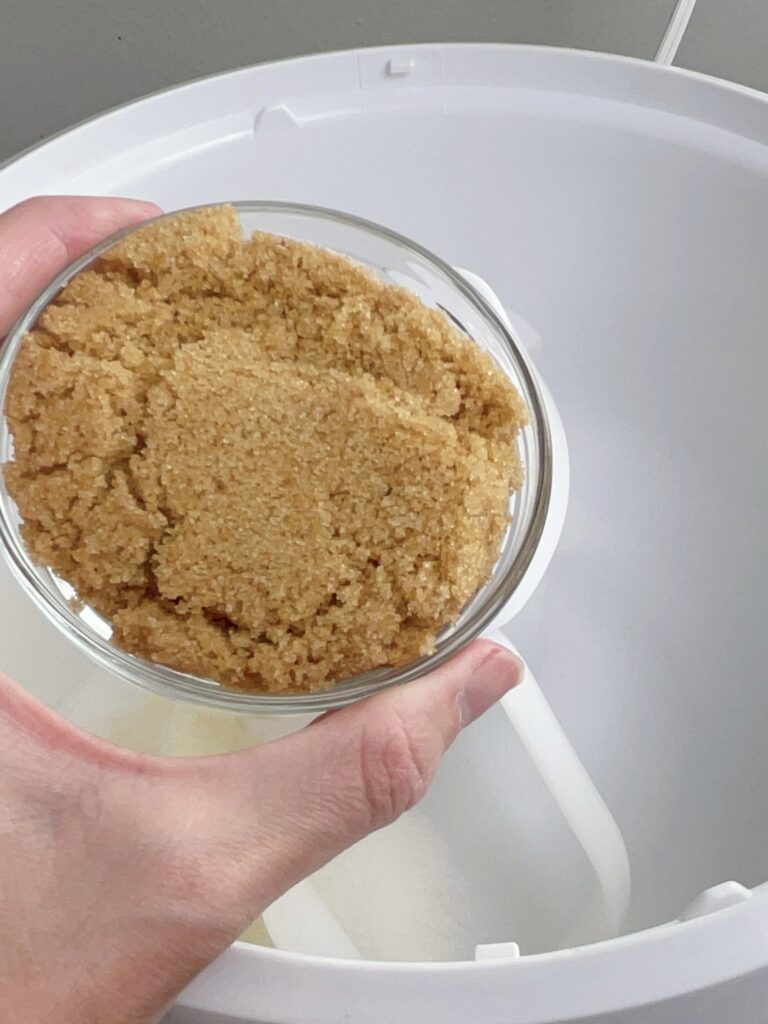 A bowl of brown sugar needed to make pumpkin sugar cookie bars.