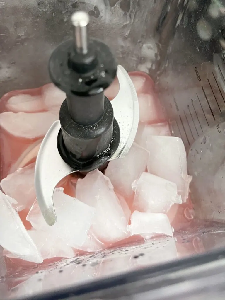 Ice cubes added to a blender with watermelon juice and lemonade powder.
