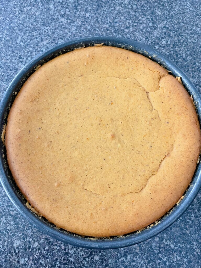 Freshly baked pumpkin cheesecake in a springform pan.