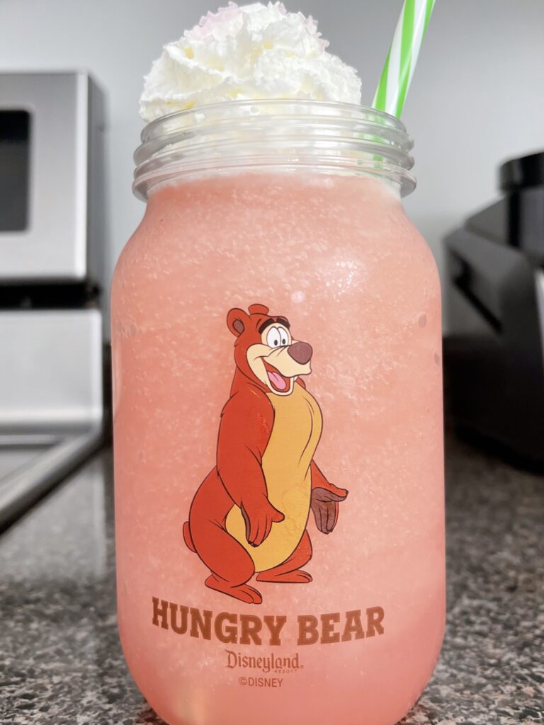 Disneyland's Watermelon Lemonade Freeze in a Mason jar with a bear on it.