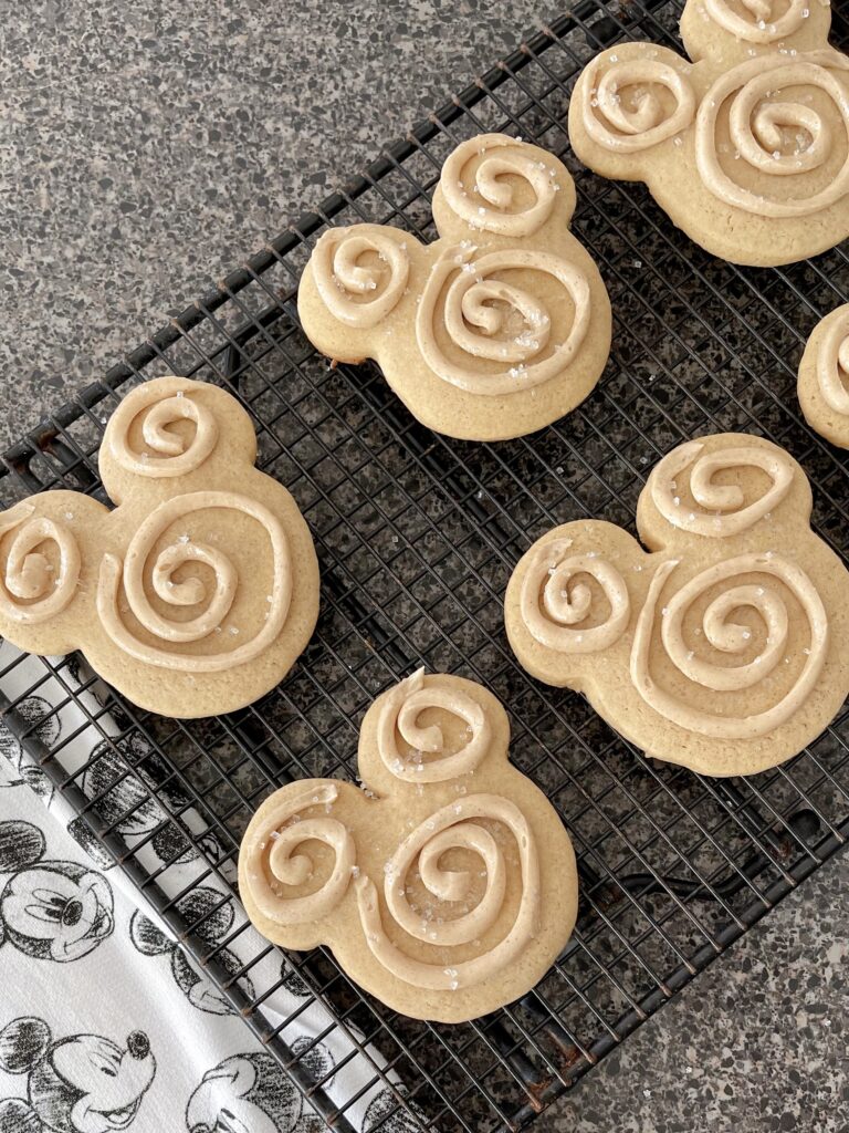 Mickey shaped churro sugar cookies on a cooling rack.