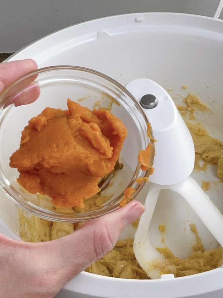 A bowl of pumpkin puree ready to mix into pumpkin sugar cookie dough.