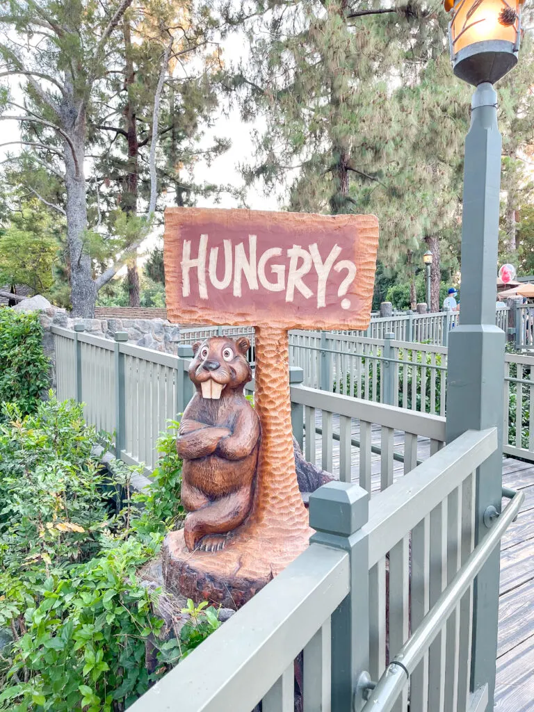A sign made of wood that says "hungry?" at <a href=