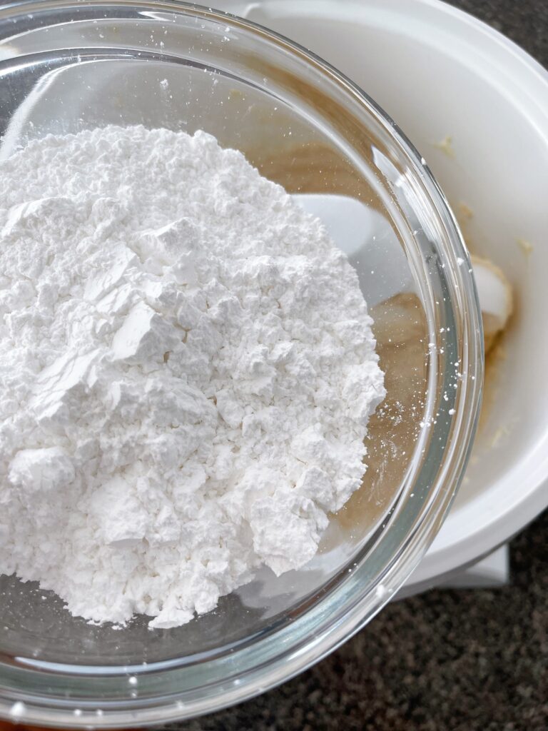A bowl of powdered sugar for brown sugar frosting.
