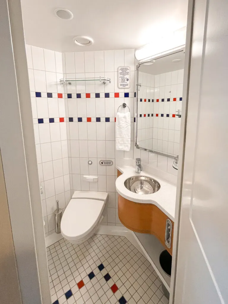 First bathroom with a toilet in Disney Dream stateroom 8614.