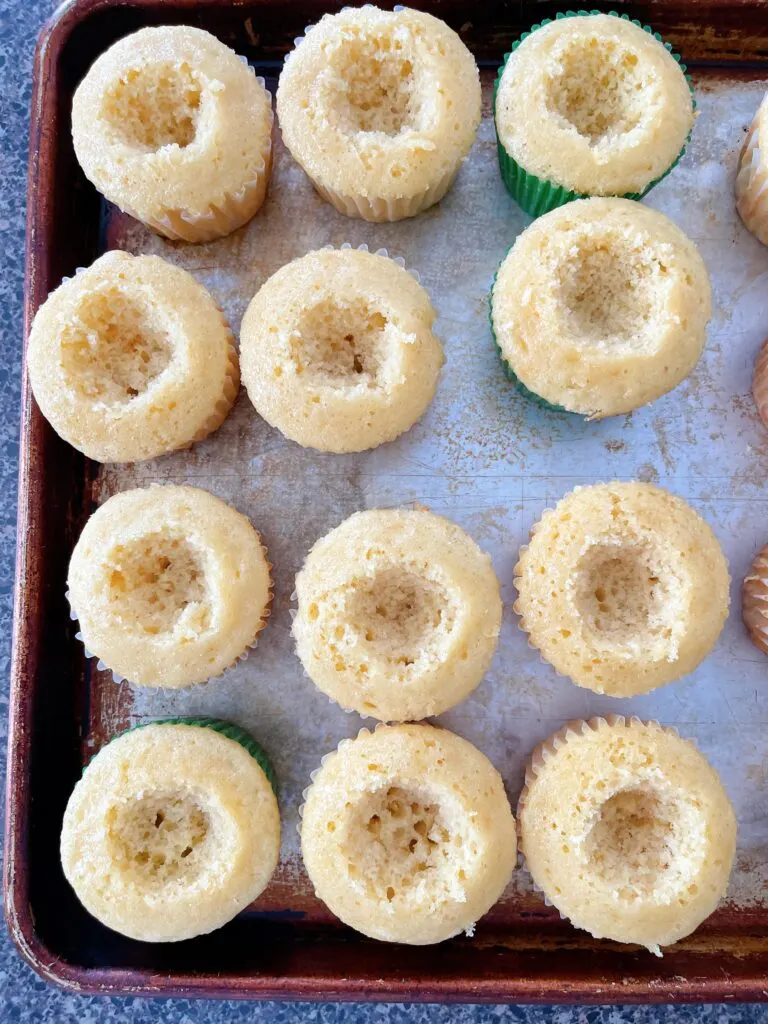 Vanilla cupcakes with the centers removed.