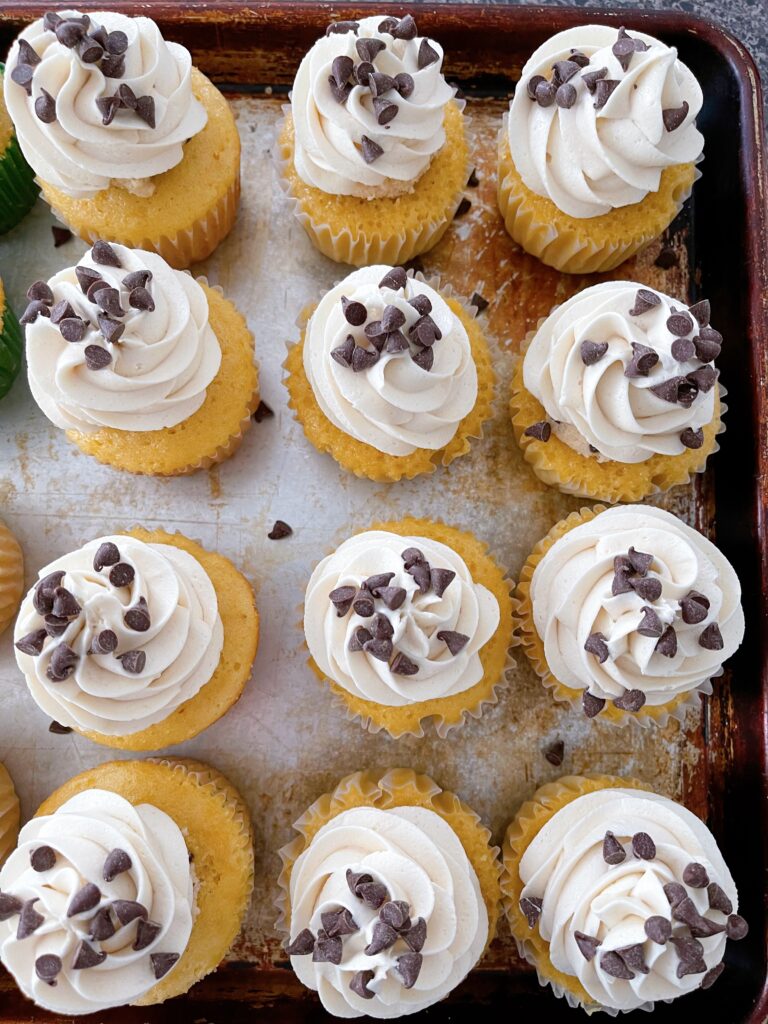 Chocolate chips on top of cookie dough cupcakes.