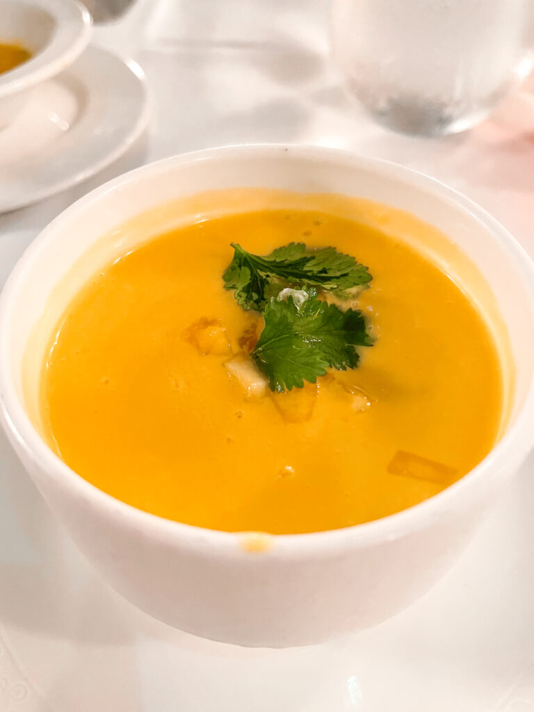 A bowl of chilled Mango Soup from the Pirate Dinner Menu on a Disney Cruise.