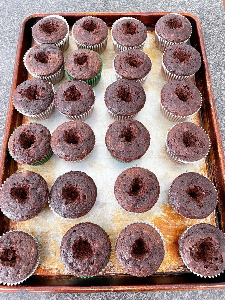 Chocolate cupcakes with the centers removed.