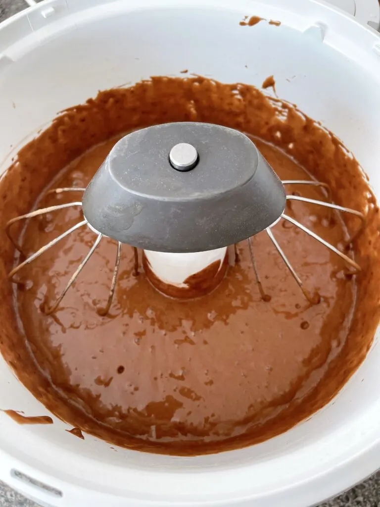 Chocolate cupcake batter in a stand mixer.