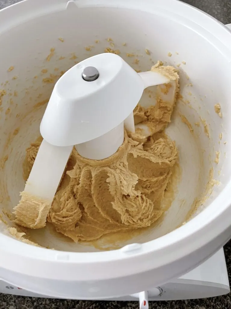 Butter, brown sugar, and sugar mixed together in a stand mixer.