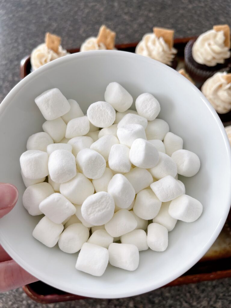 A bowl of mini marshmallows to go on top of hot chocolate cupcakes.