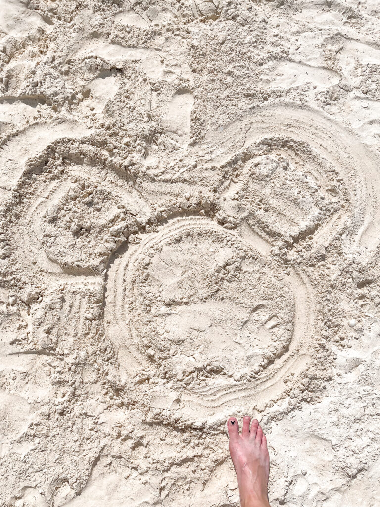 A Mickey Mouse shaped drawn in the sand on Castaway Cay.