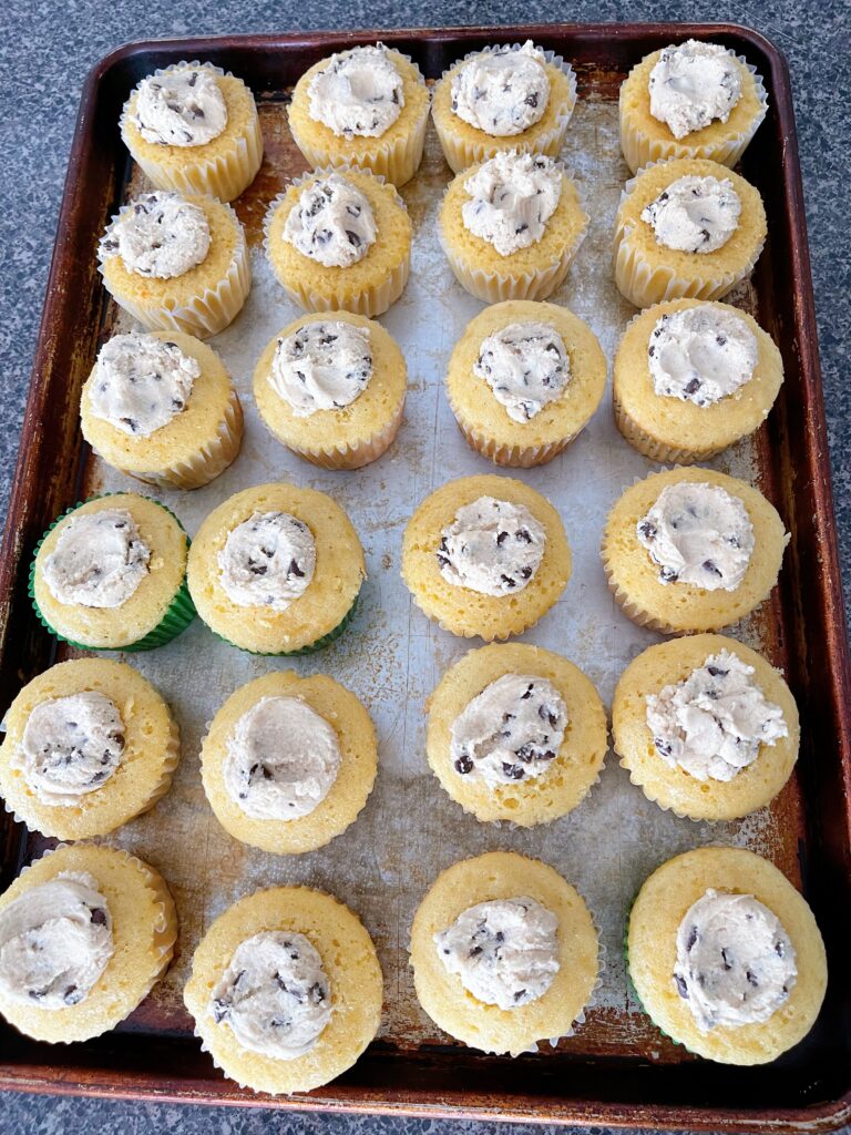 Cookie dough stuffed into the middle of cupcakes.