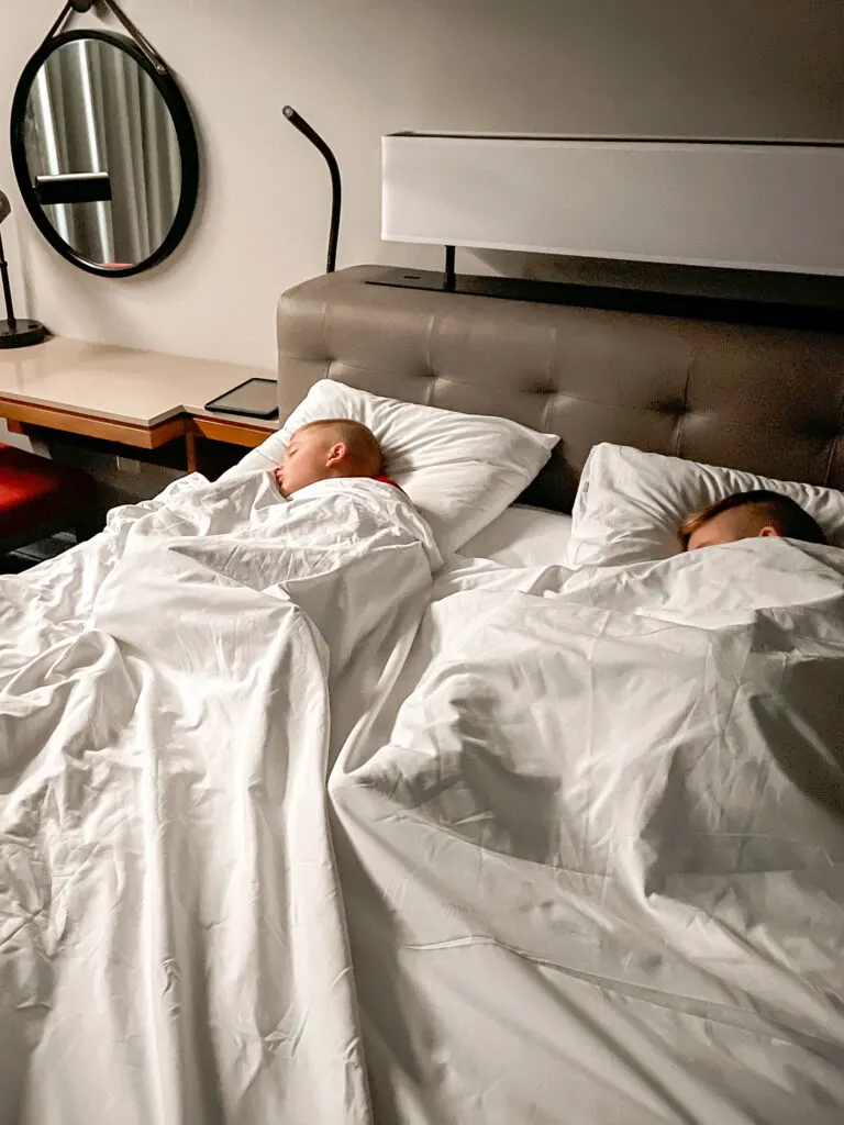 Two kids sleeping at Hyatt Regency Orlando Airport before a Disney Cruise.