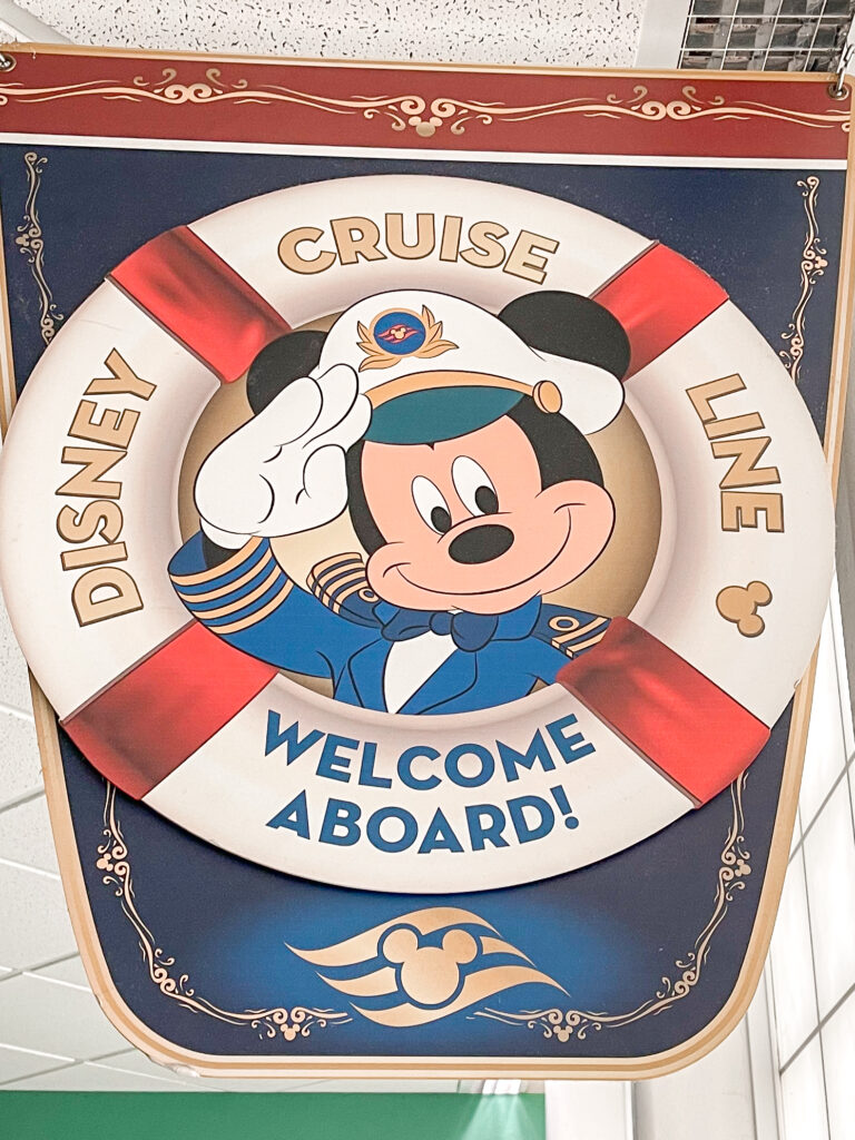 A sign with a picture of Mickey Mouse in the center of a life preserver that says "Disney Cruise Line Welcome Aboard!"