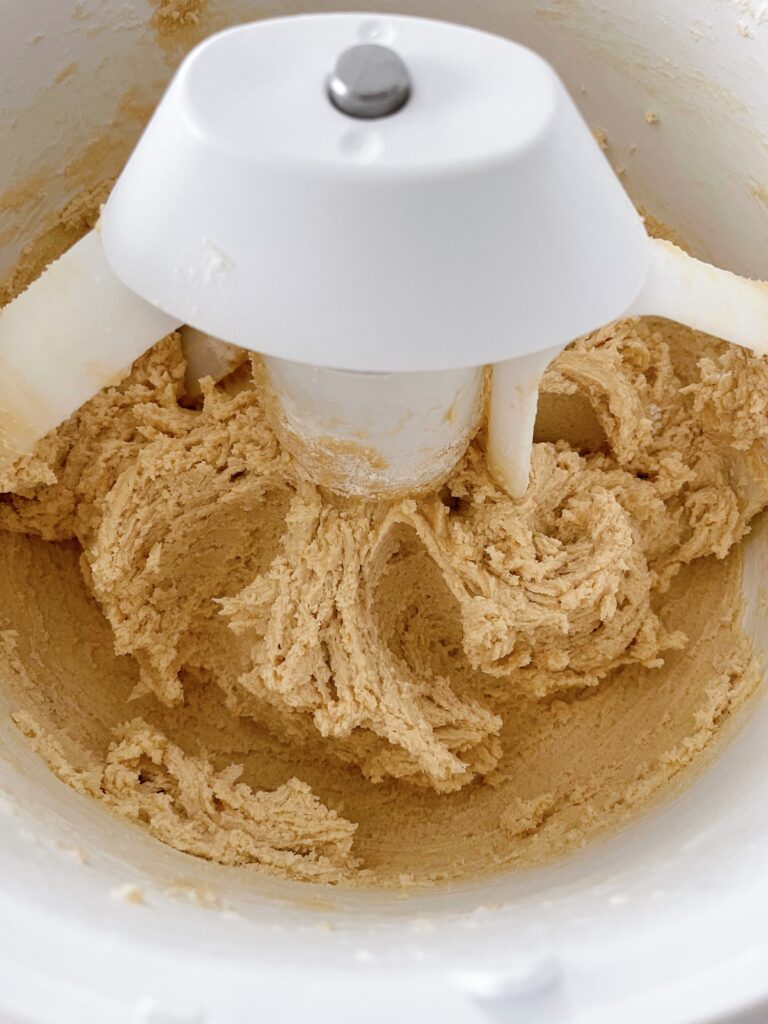 Cookie dough in a stand mixer.
