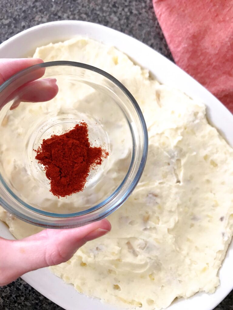 A bowl of paprika to sprinkle on mashed potatoes.