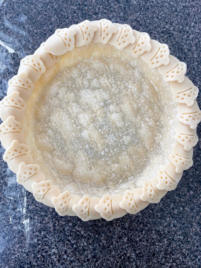 A partially baked pie crust.