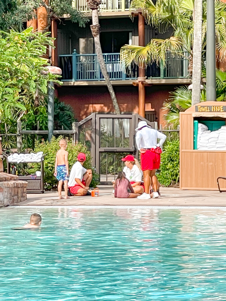 Disney cast members doing recreational activities near the pool of Animal Kingdom Lodge.