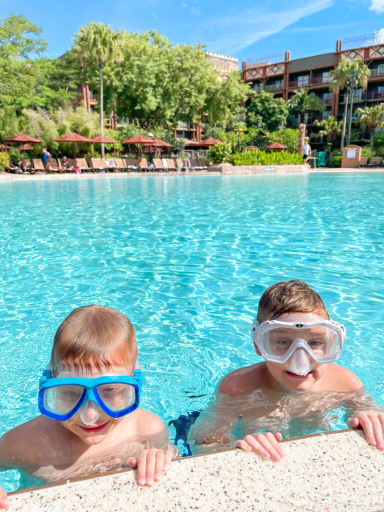 Two kids swimming in the pool at Disney's Magical Express.