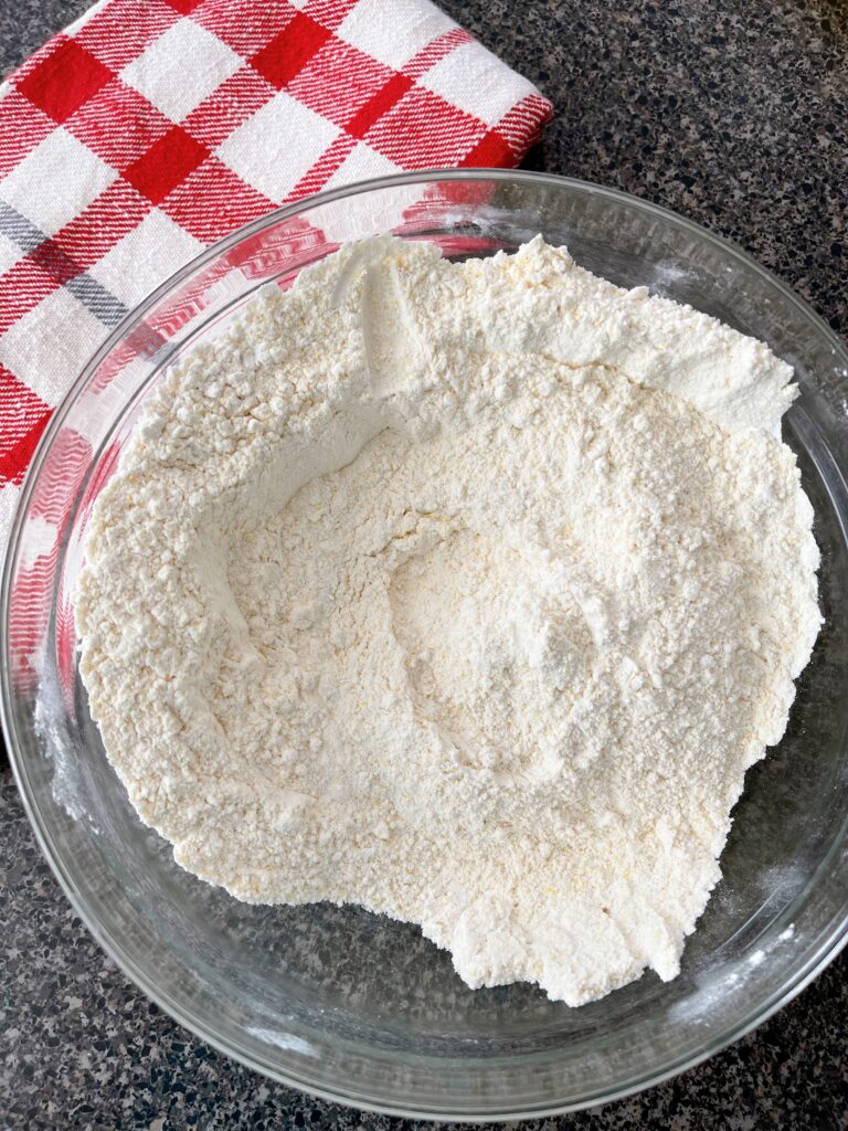 Dry ingredients in a bowl mixed together to make sweet cornbread.