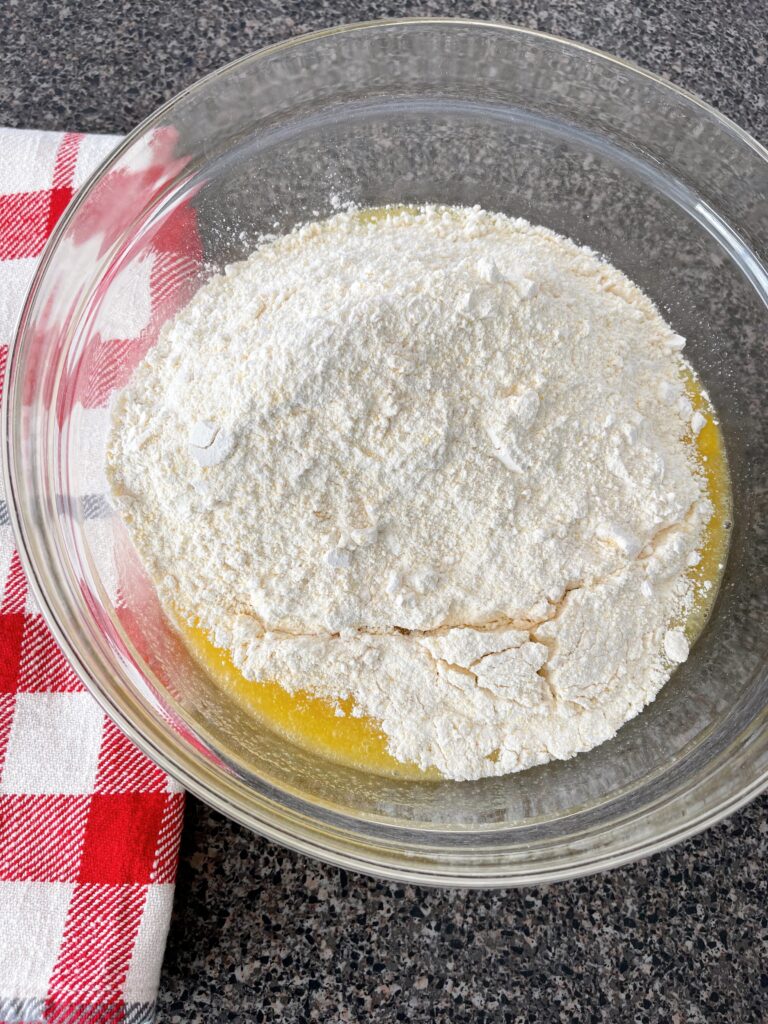 Cornbread wet and dry ingredients in a bowl.