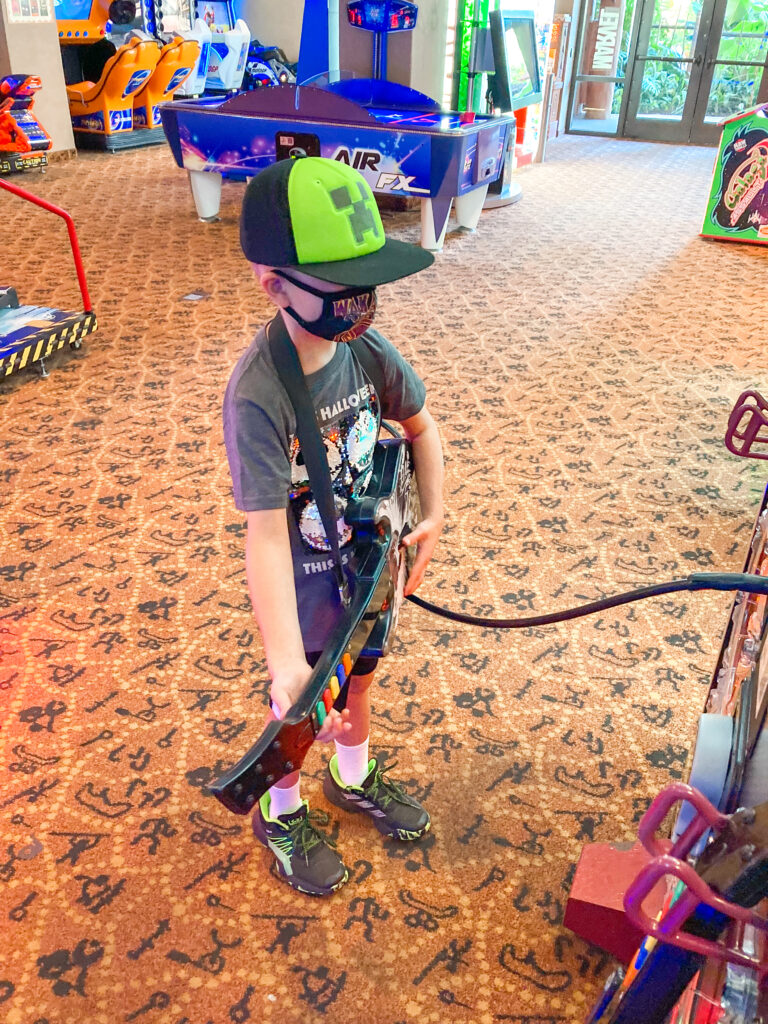 A child playing guitar hero at the arcade at Disney's Animal Kingdom Lodge.