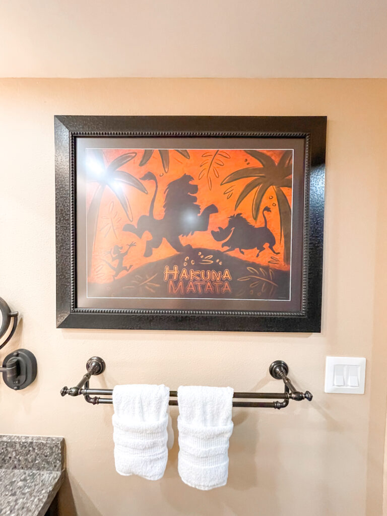 A Lion King picture hanging in the bathroom of a standard room at Disney's Animal Kingdom Lodge.