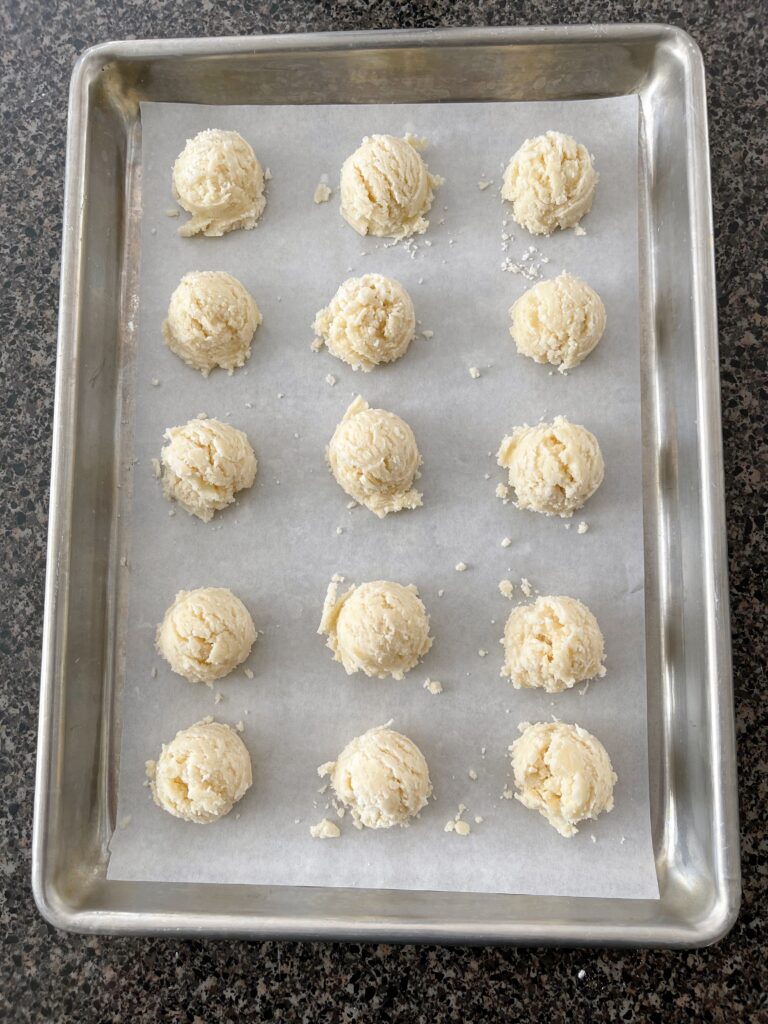 Balls of Melt Away Cookie Dough on a baking sheet lined with parchment paper.