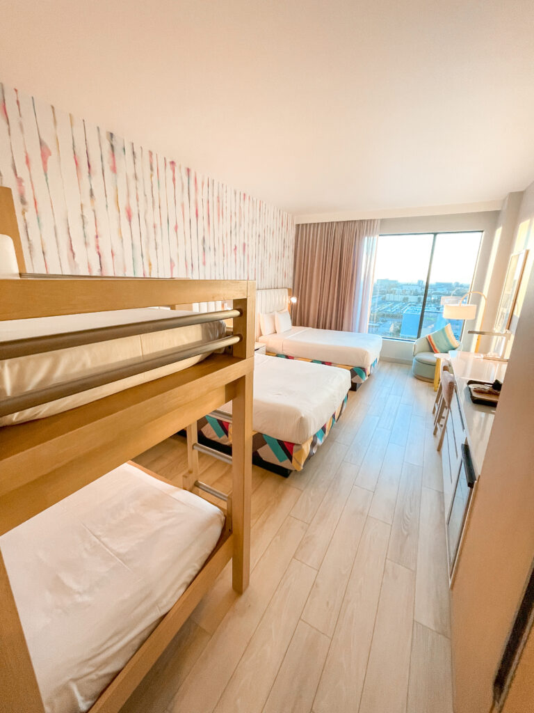 A hotel room with two queen beds and a set of bunk beds at Radisson Blu Anaheim near Disneyland.