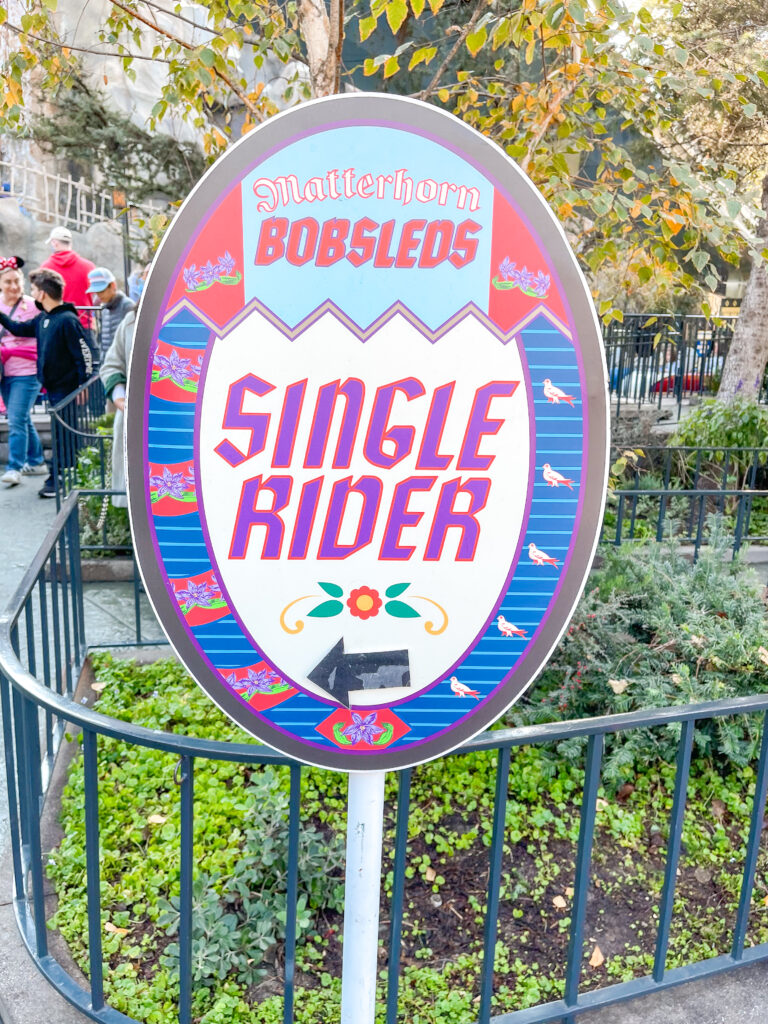 A Single Rider Line sign outside Matterhorn Bobsleds.