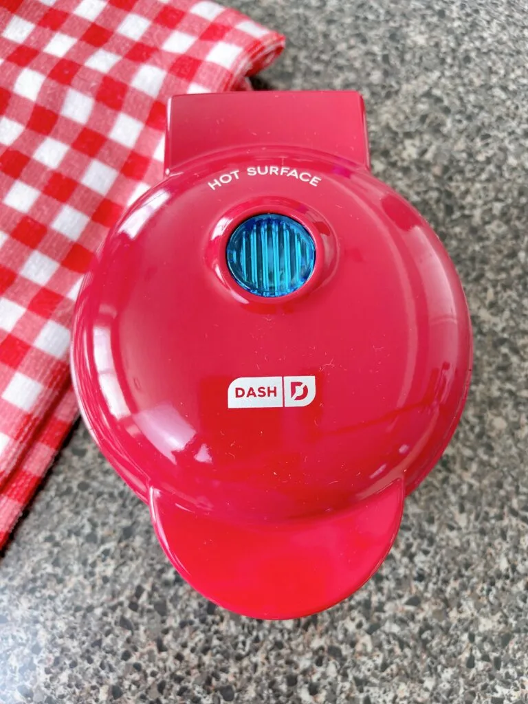 A red mini Dash Waffle Iron.