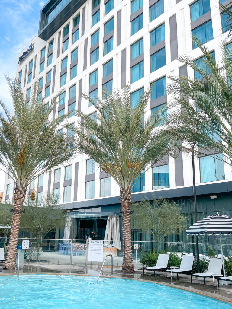 Seating and umbrellas in the pool area of Radisson Blu Anaheim.