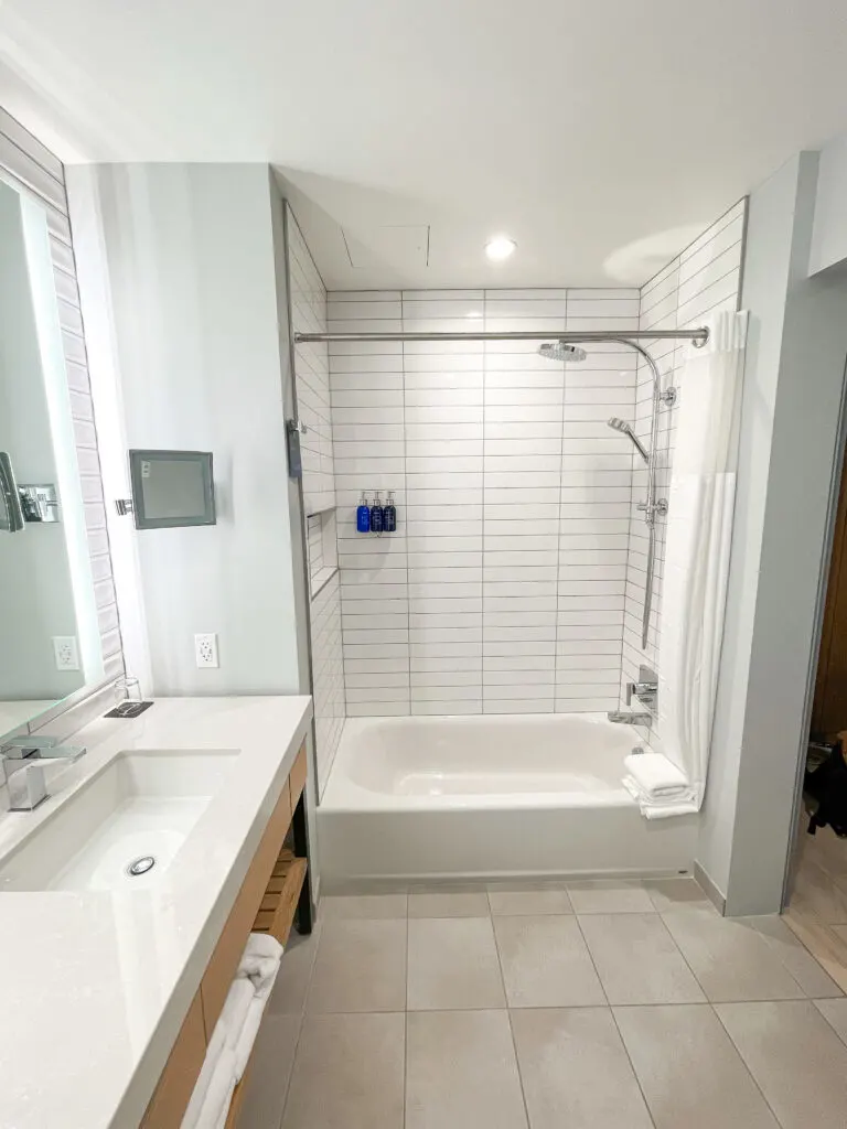 Shower and tub combination in a guest room.
