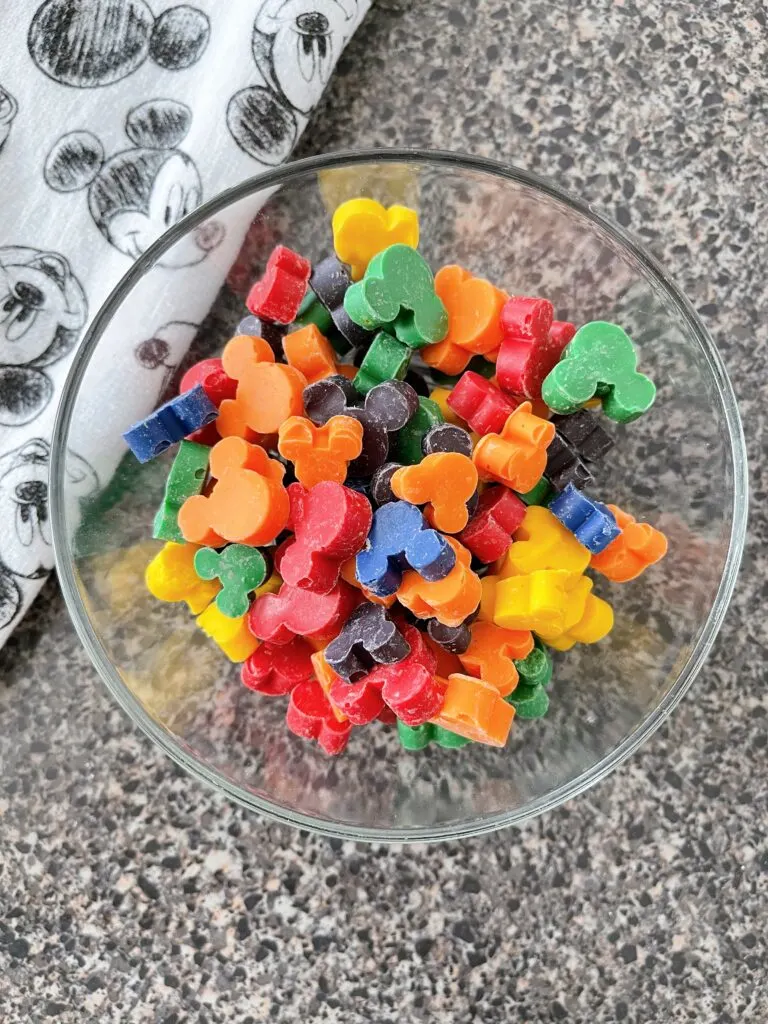 A bowl of rainbow mickey mouse-shaped chocolate chips.