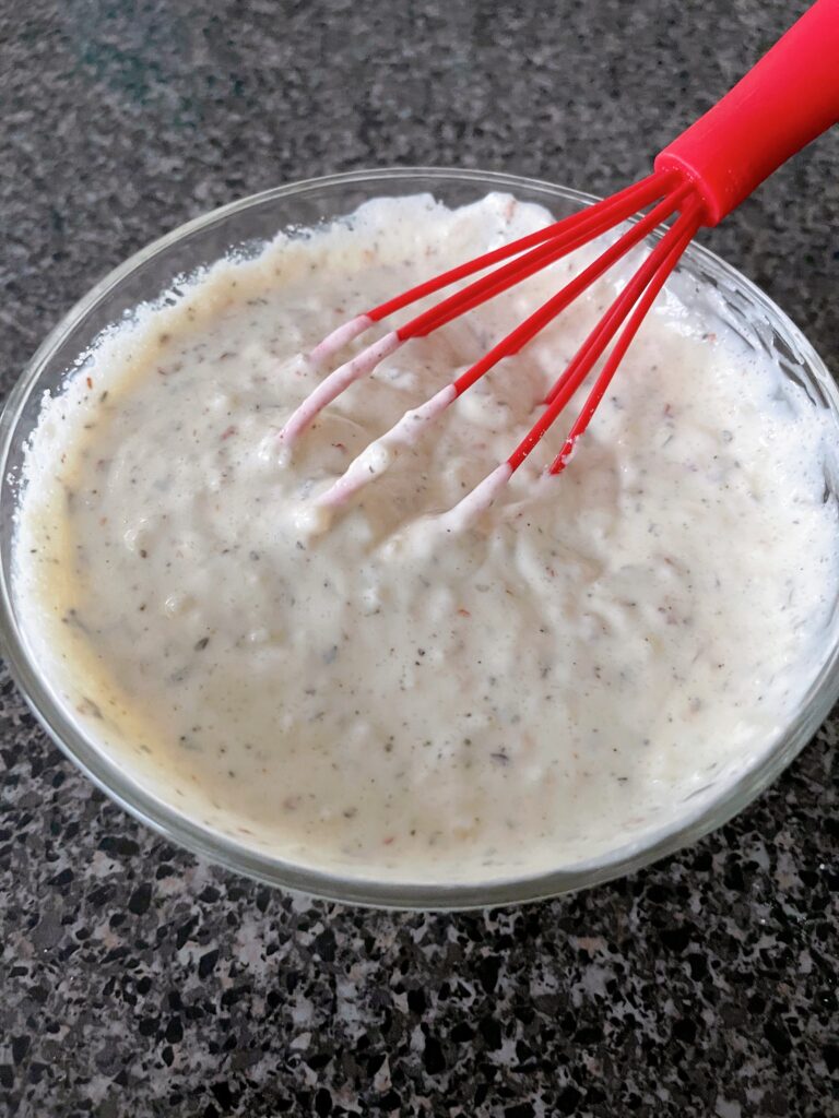 A bowl of homemade garlic parmesan wing sauce from Buffalo Wild Wings.