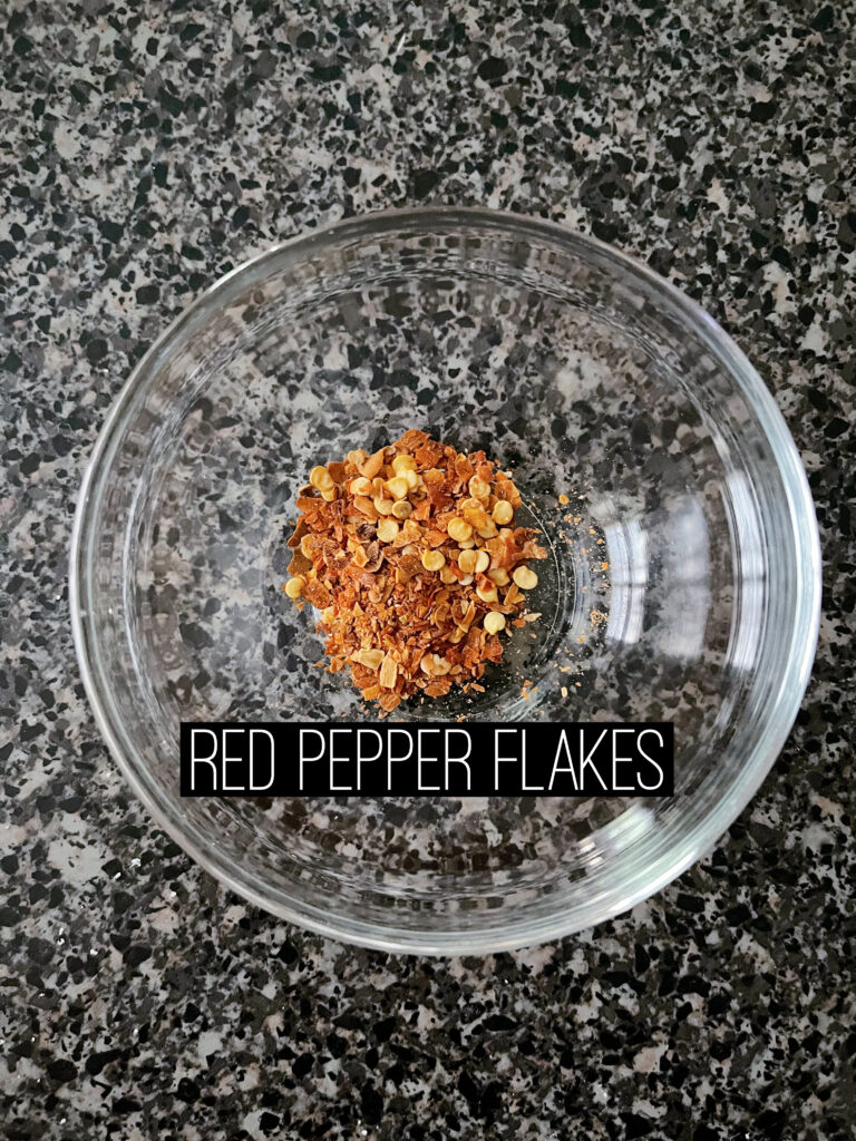 A bowl of red pepper flakes.