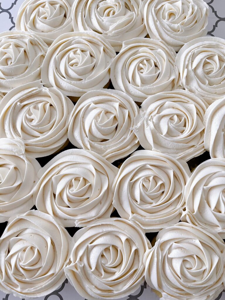 Classic vanilla buttercream frosting piped onto cupcakes.