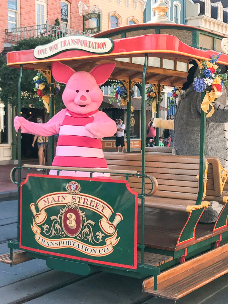 Piglet riding a Main Street vehicle at Disney World.