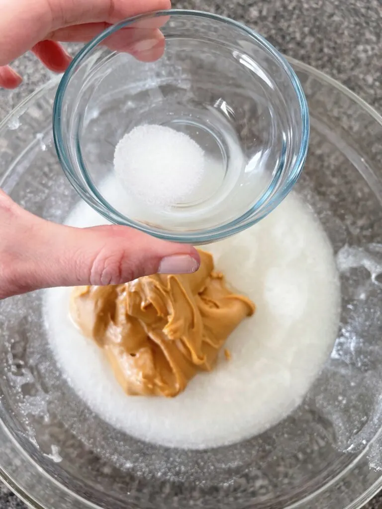 Once the sugar has dissolved into the corn syrup, stir in the salt and 1 cup of the creamy peanut butter.
