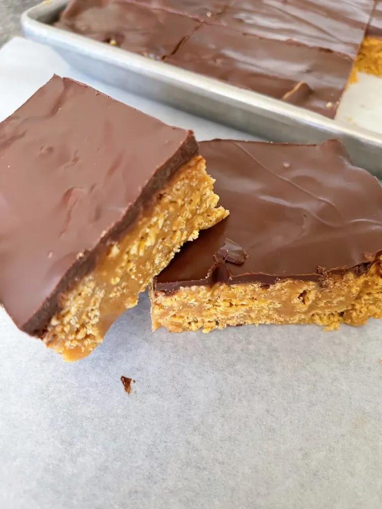 No bake chocolate peanut butter Chex bars on parchment paper.